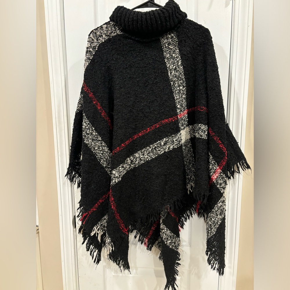 Black with red and cream turtleneck poncho.